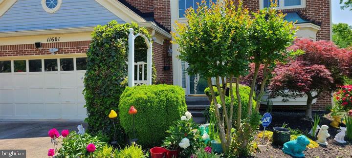 11601 Lighthouse Drive Laurel, MD 20708 - Photo 2 of 21 Charming curb appeal with vibrant blooms.