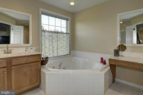 2101 Link Road Silver Spring, MD 20905 - Photo 17 of 30 a bathroom with a tub sink and mirror