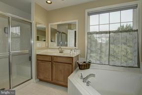 2101 Link Road Silver Spring, MD 20905 - Photo 18 of 30 a bathroom with a tub sink and mirror