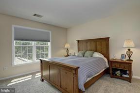 2101 Link Road Silver Spring, MD 20905 - Photo 23 of 30 a bedroom with a bed and a table lamp