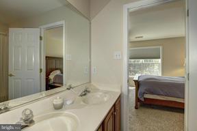2101 Link Road Silver Spring, MD 20905 - Photo 24 of 30 a en suite bathroom with a granite countertop tub sink and mirror
