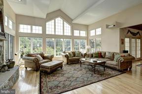 2101 Link Road Silver Spring, MD 20905 - Photo 10 of 30 a living room with furniture large windows and wooden floor