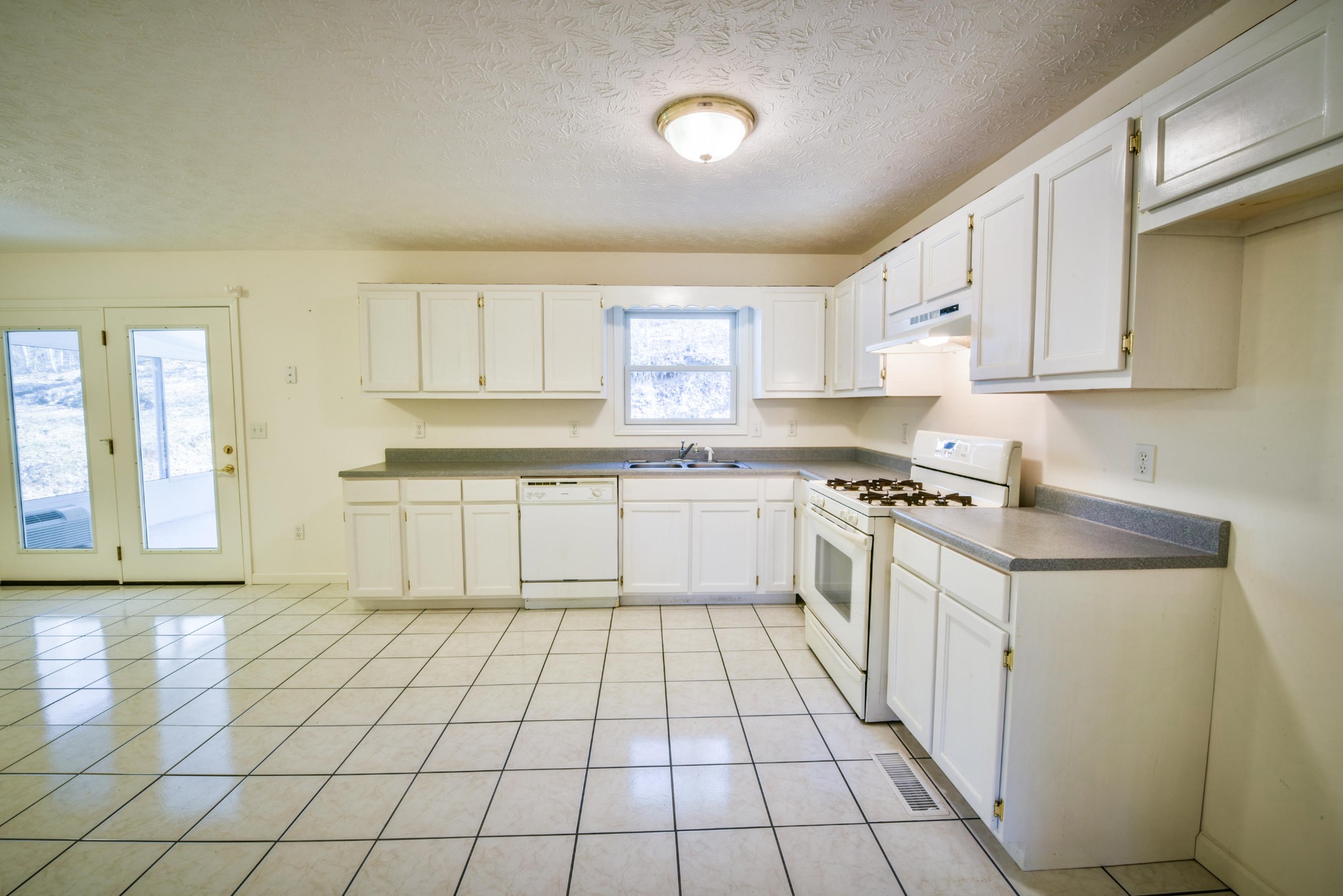 1120 Autumn Breeze Road Newport, TN 37821 - Photo 12 of 38 a kitchen with a stove top oven sink and cabinets
