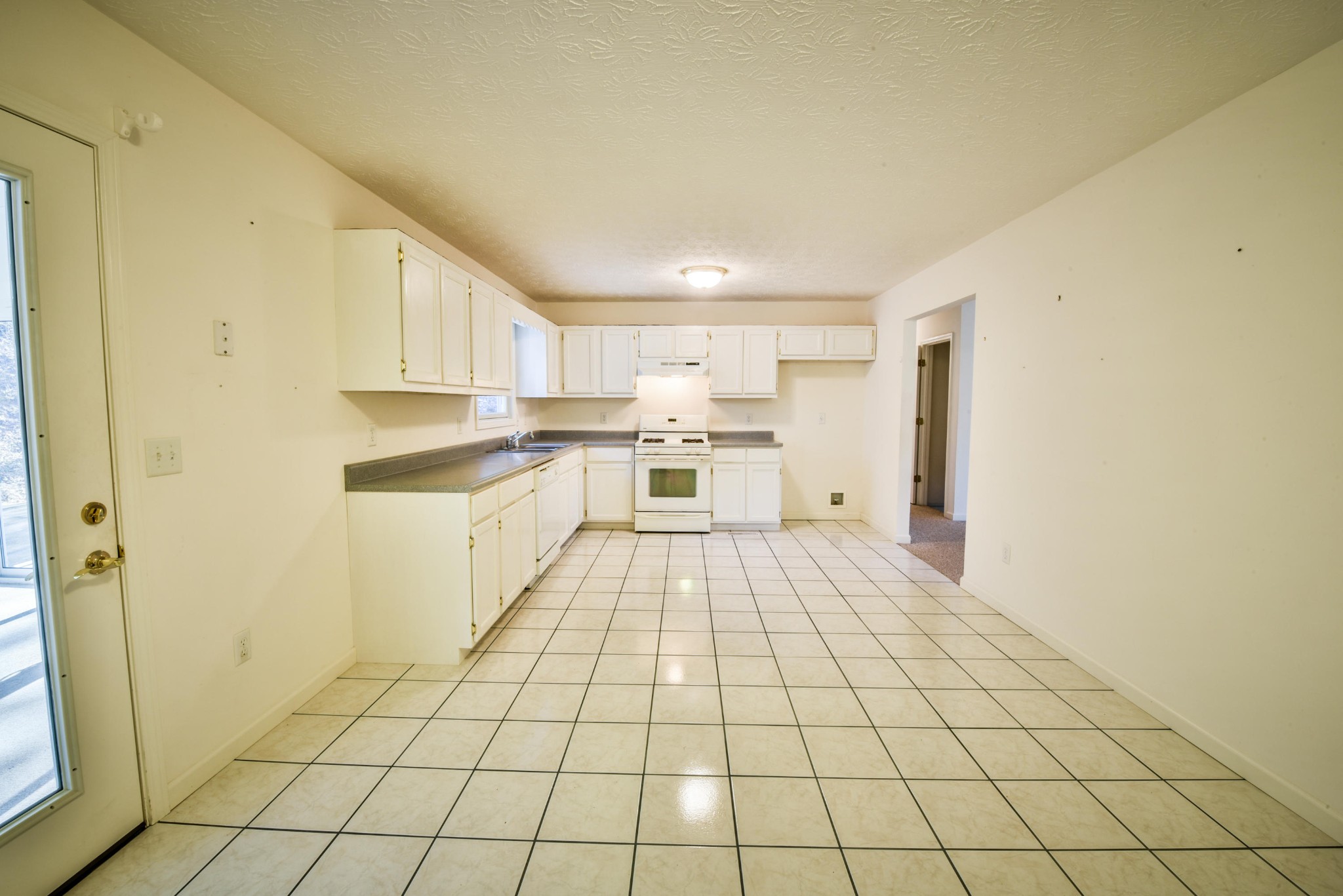 1120 Autumn Breeze Road Newport, TN 37821 - Photo 13 of 38 a large white kitchen with a sink and cabinets