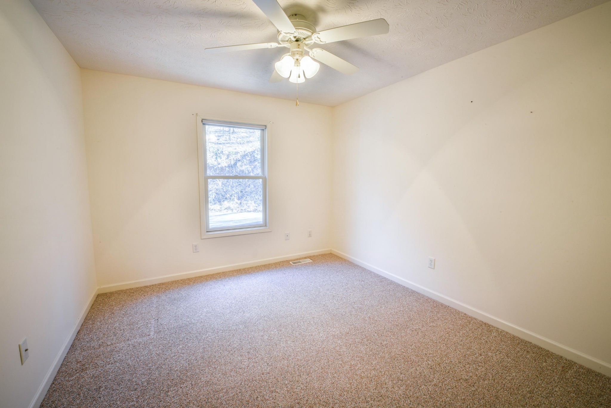1120 Autumn Breeze Road Newport, TN 37821 - Photo 27 of 38 an empty room with a window and a fan