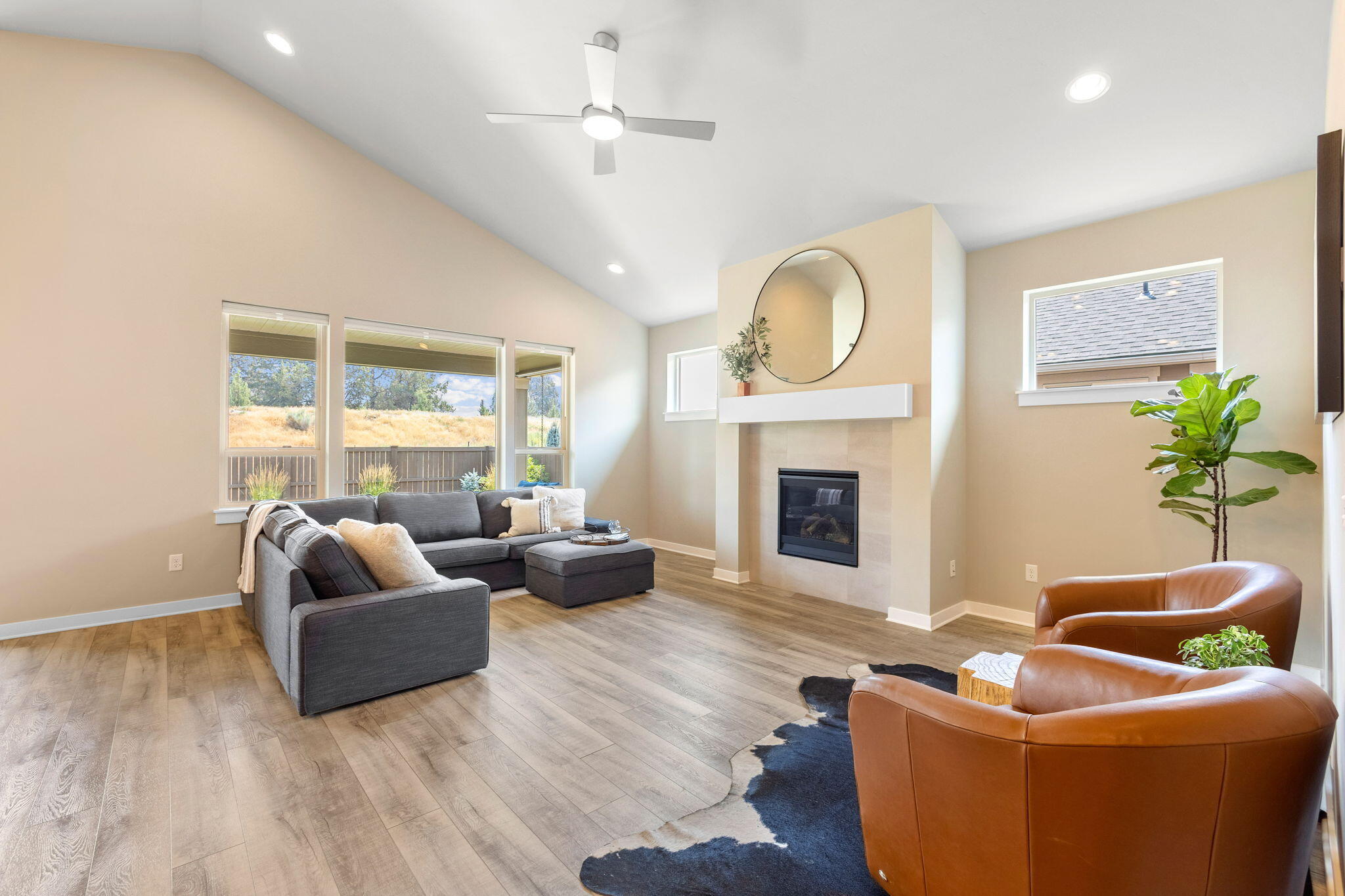4396 Southwest 36th Street Redmond, OR 97756 - Photo 7 of 36 Light, bright, and fresh great room with vaulted ceilings and tile surround gas fireplace.