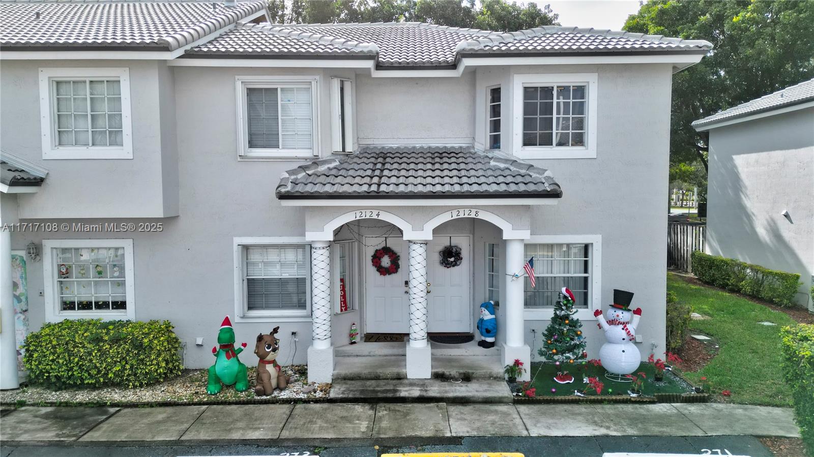 12124 Southwest 143rd Lane, Unit 85 Miami, FL 33186 - Photo 1 of 44 a front view of a house with garden