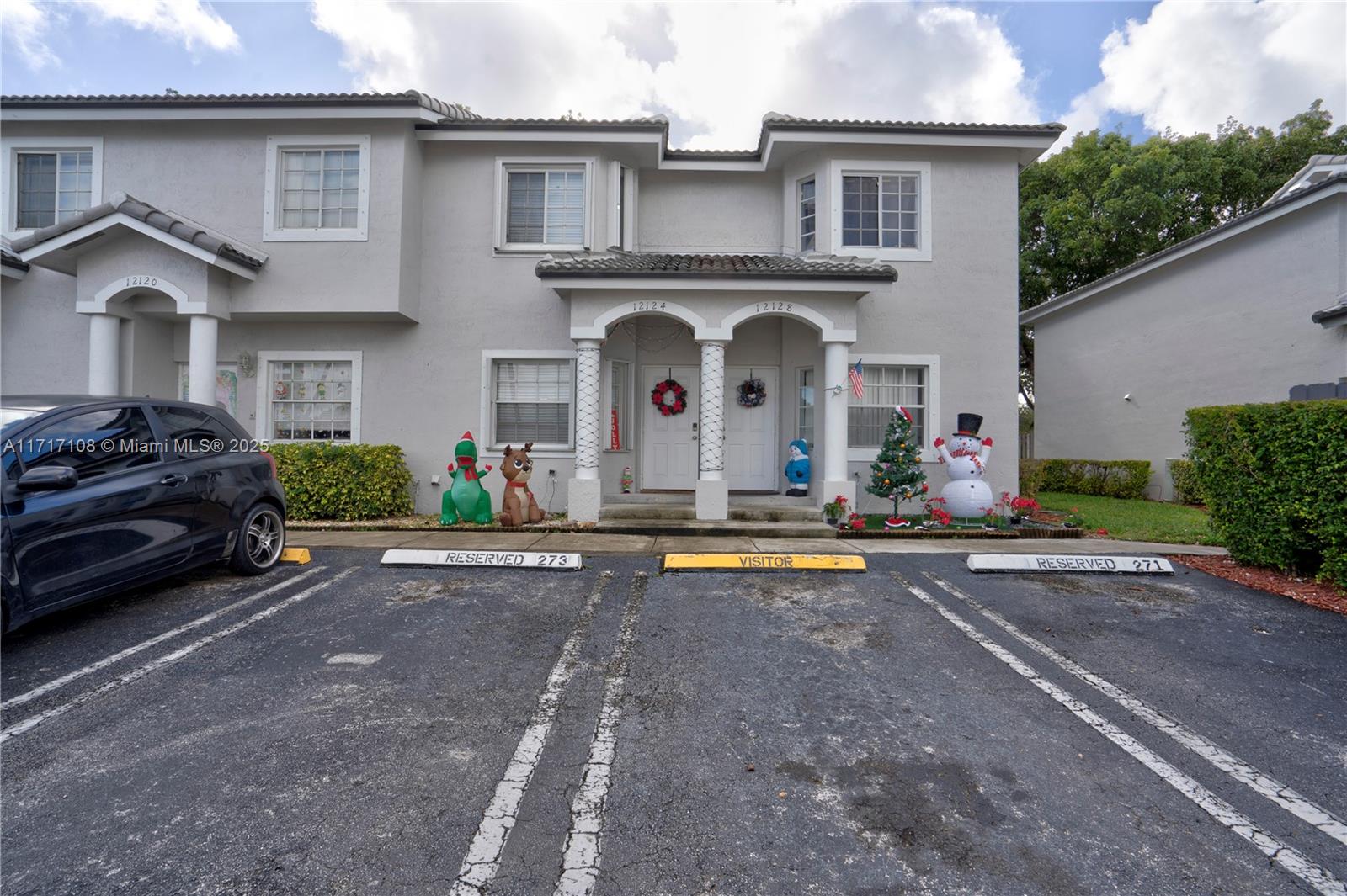12124 Southwest 143rd Lane, Unit 85 Miami, FL 33186 - Photo 18 of 44 a front view of a house with swimming pool and a yard