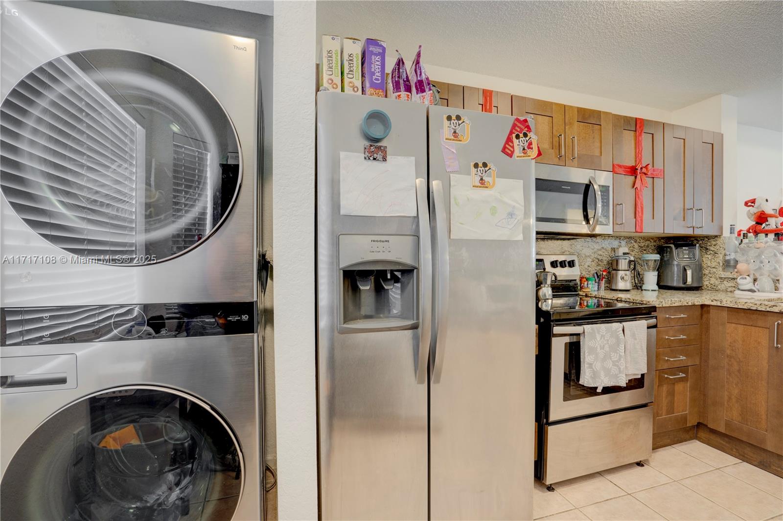 12124 Southwest 143rd Lane, Unit 85 Miami, FL 33186 - Photo 25 of 44 a kitchen with stainless steel appliances granite countertop a refrigerator and a stove