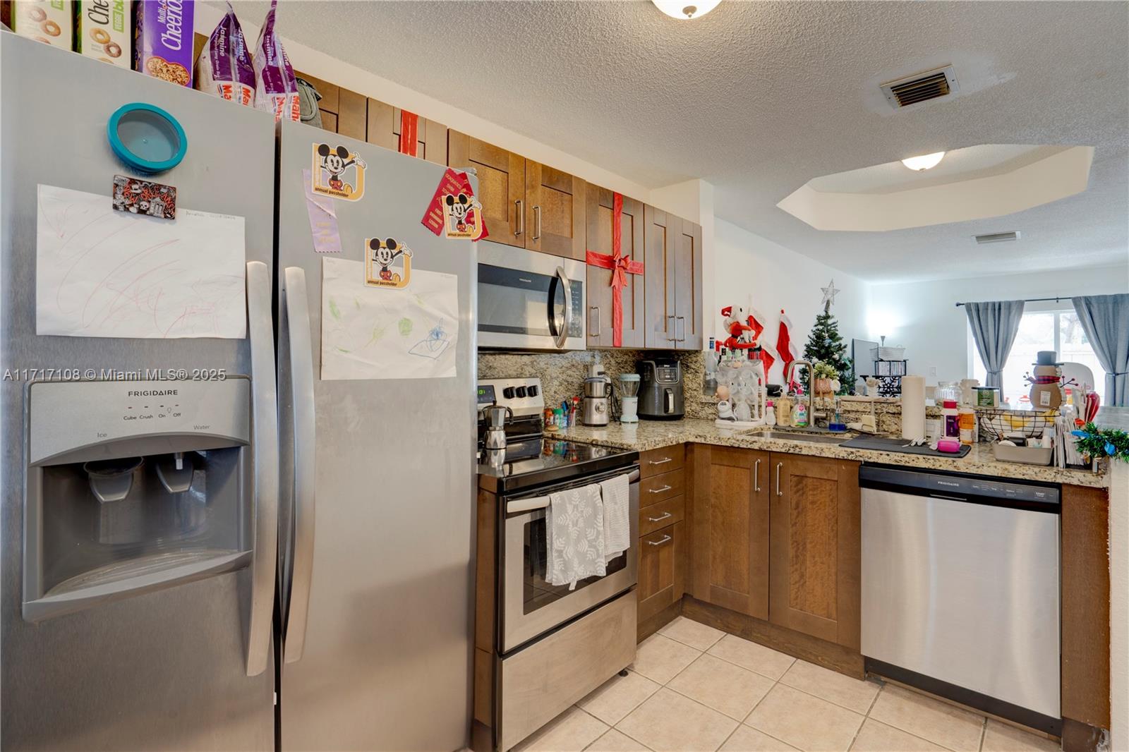 12124 Southwest 143rd Lane, Unit 85 Miami, FL 33186 - Photo 26 of 44 a kitchen with stainless steel appliances granite countertop a refrigerator and a sink
