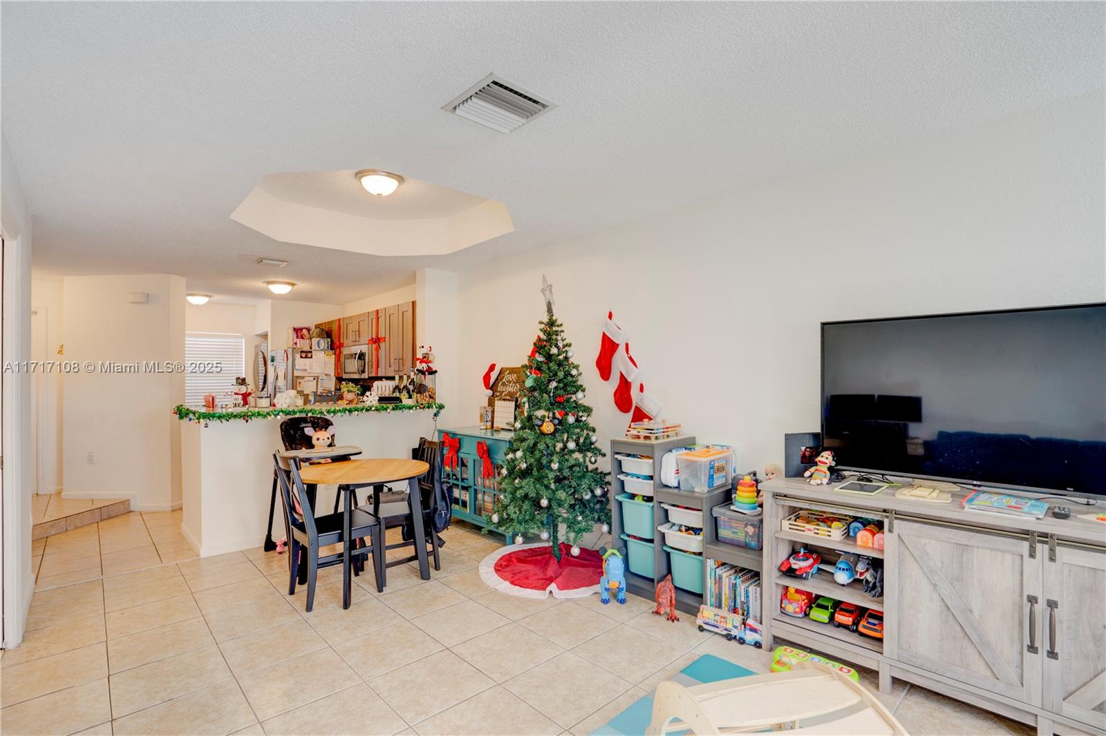 12124 Southwest 143rd Lane, Unit 85 Miami, FL 33186 - Photo 30 of 44 a view of dining room with furniture and a kitchen