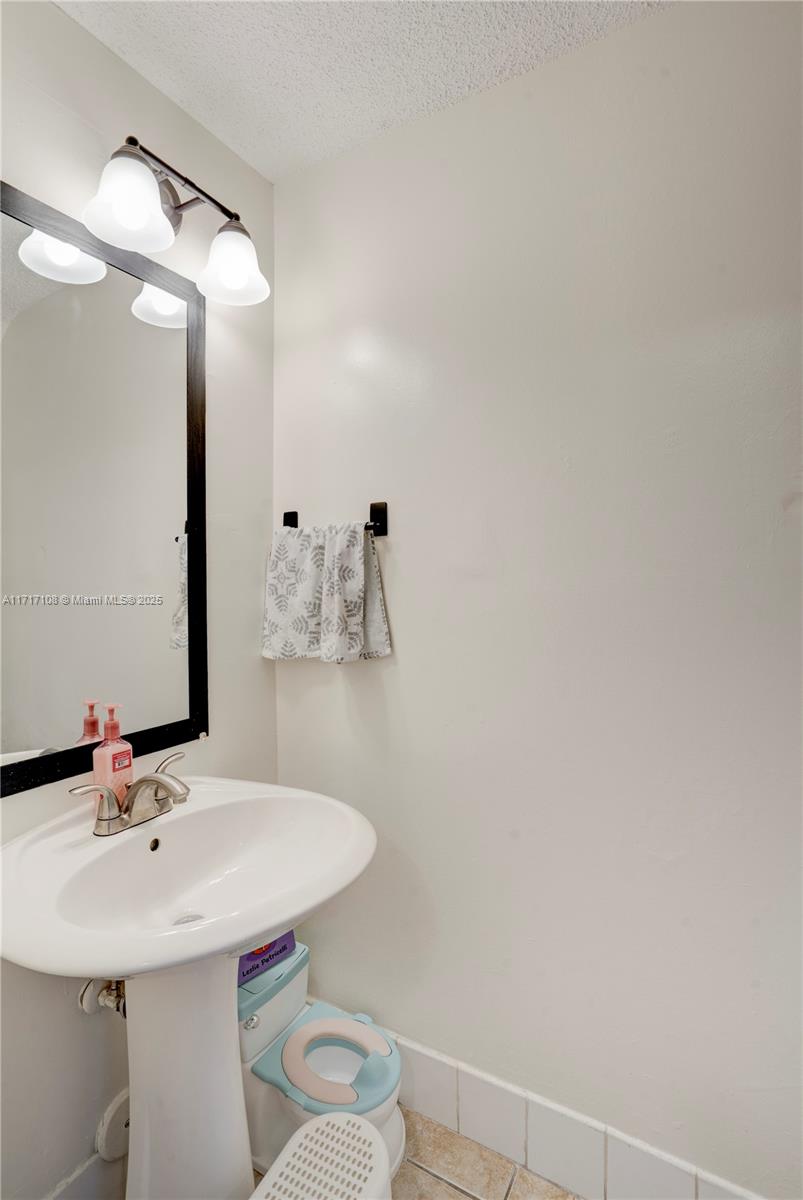 12124 Southwest 143rd Lane, Unit 85 Miami, FL 33186 - Photo 37 of 44 a bathroom with a sink and a mirror