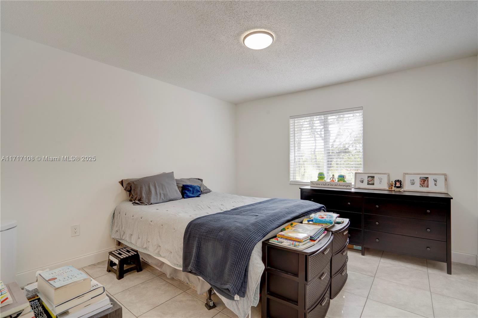 12124 Southwest 143rd Lane, Unit 85 Miami, FL 33186 - Photo 41 of 44 a bedroom with a bed and a window