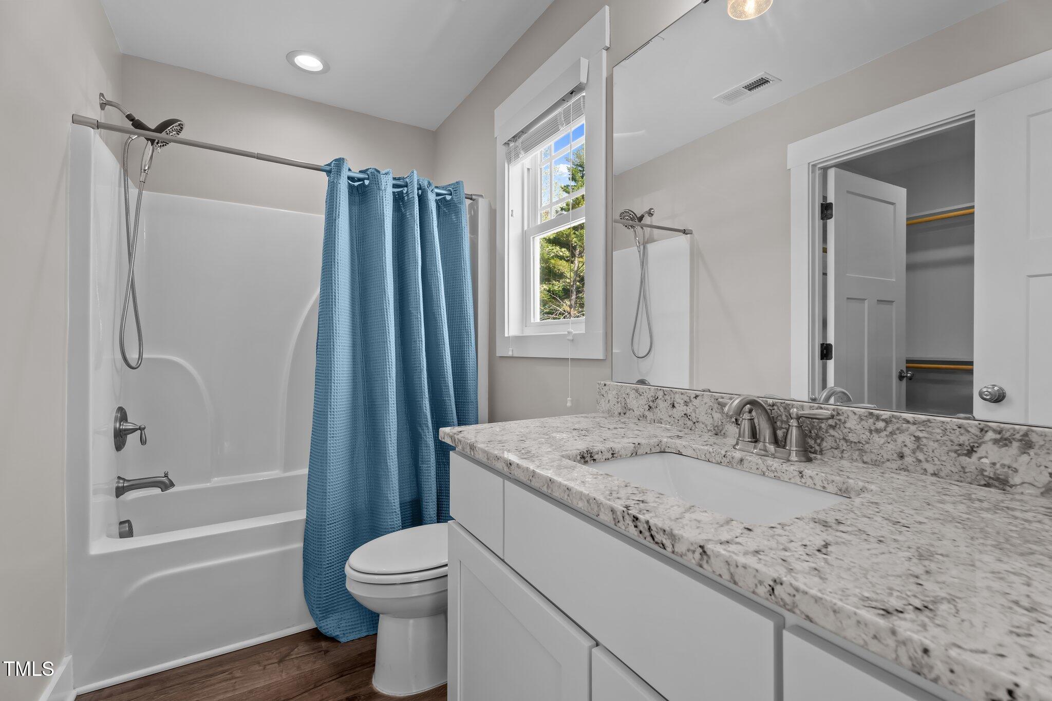 1914 Jack Road Clayton, NC 27520 - Photo 16 of 38 a bathroom with a granite countertop sink toilet and shower