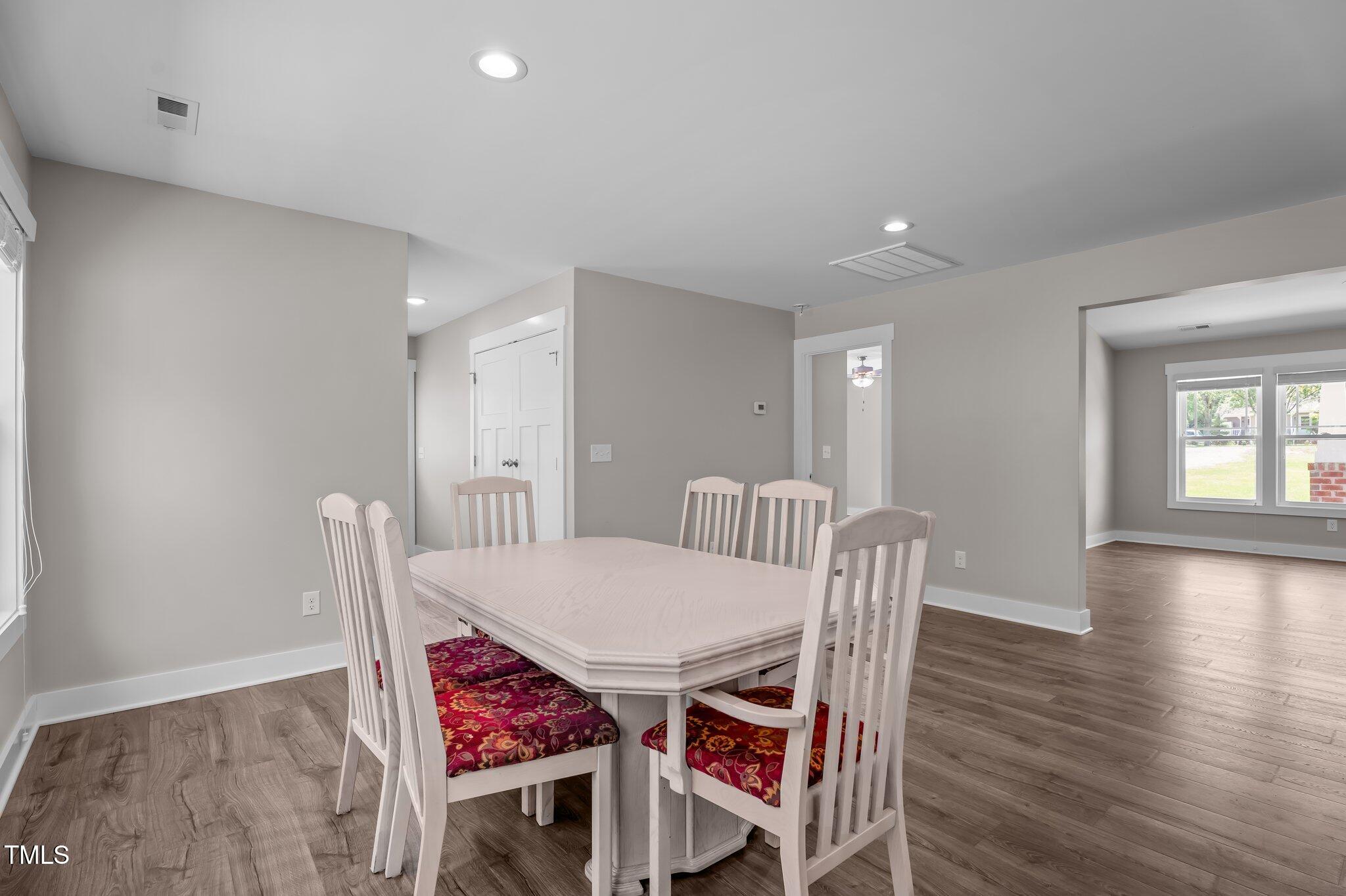 1914 Jack Road Clayton, NC 27520 - Photo 22 of 38 a view of a dining room with furniture and wooden floor