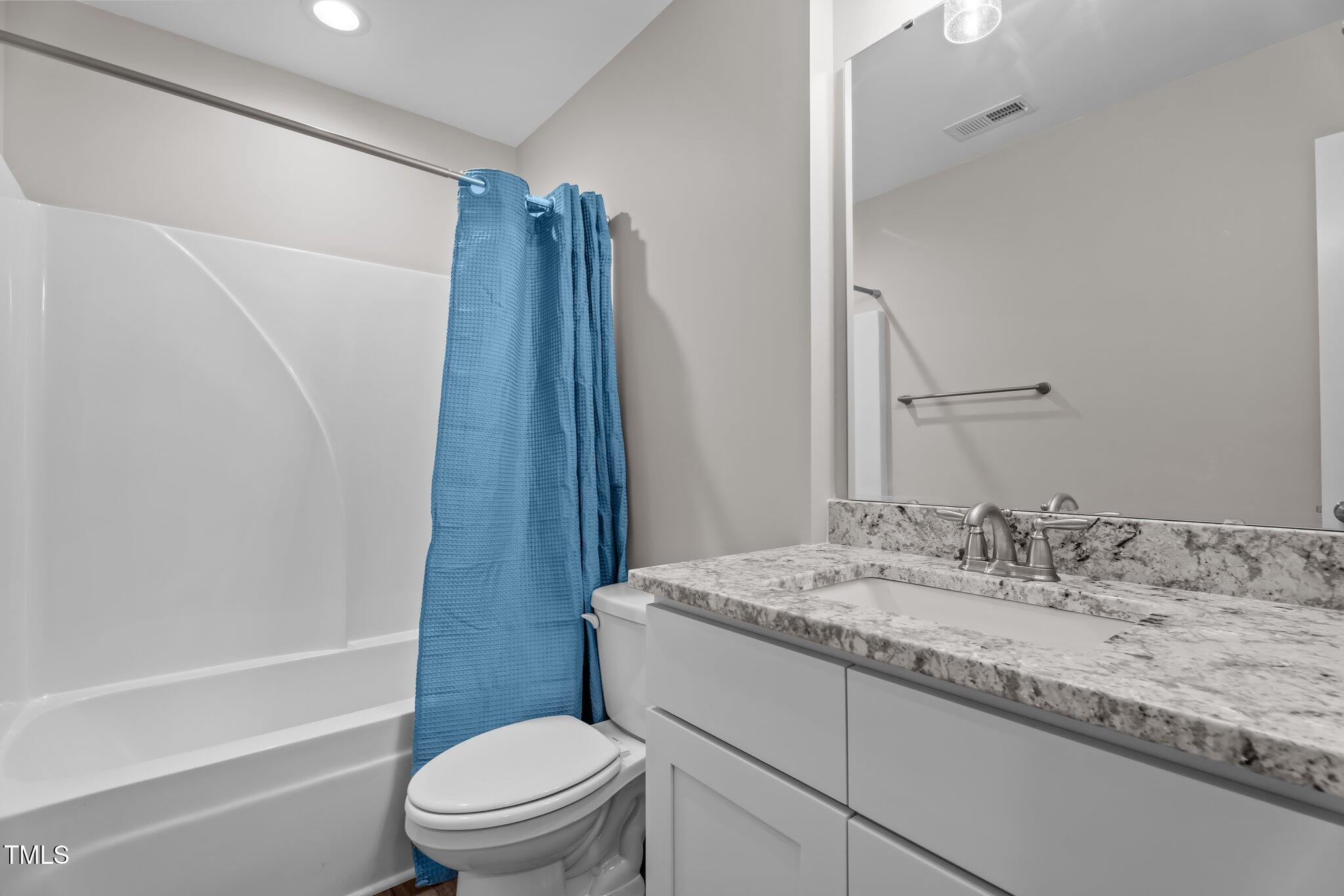 1914 Jack Road Clayton, NC 27520 - Photo 29 of 38 a bathroom with a granite countertop sink toilet and shower