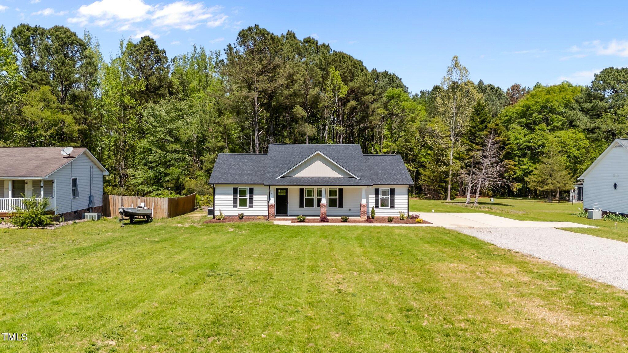 1914 Jack Road Clayton, NC 27520 - Photo 3 of 38 a front view of a house with a yard and trees
