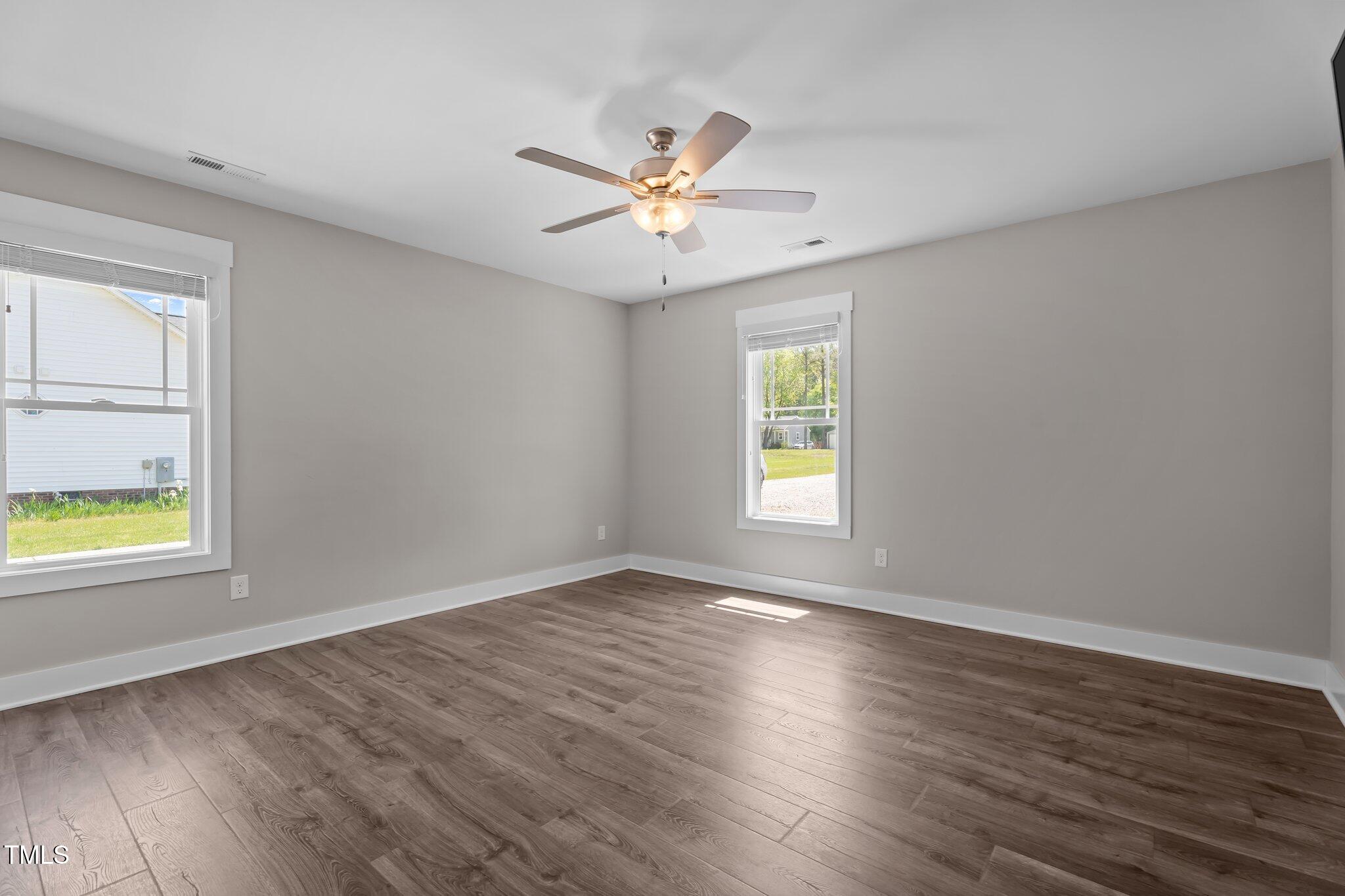 1914 Jack Road Clayton, NC 27520 - Photo 35 of 38 an empty room with window and wooden floor