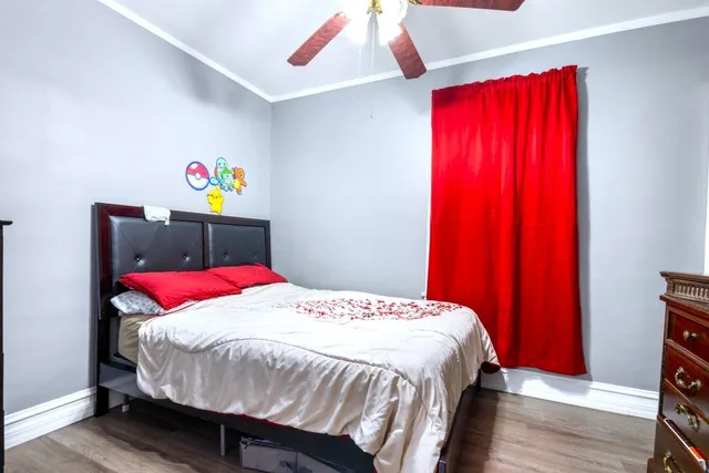 a bedroom with a bed and large windows