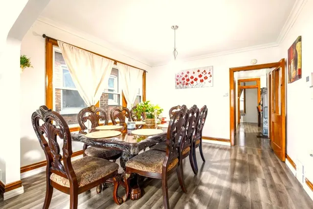 a view of a dining room with furniture and a window