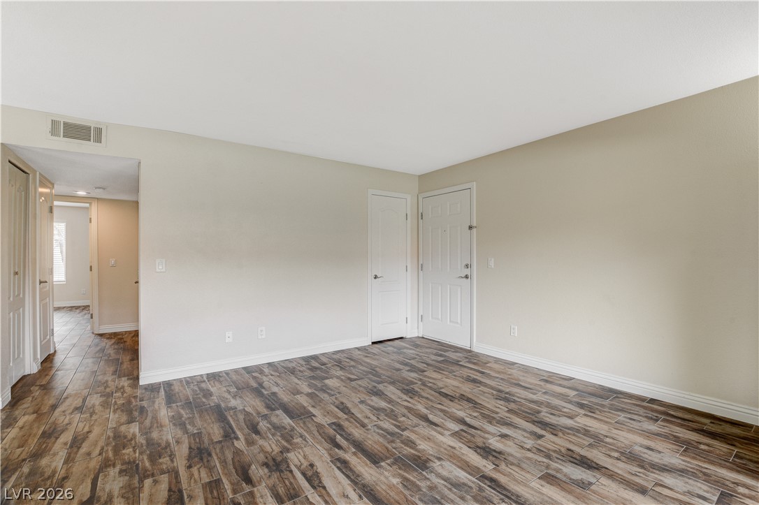 7200 West Pirates Cove Road, Unit 1026 Las Vegas, NV 89145 - Photo 6 of 35 This versatile room features durable flooring and ample natural light, ideal for a flexible living space.