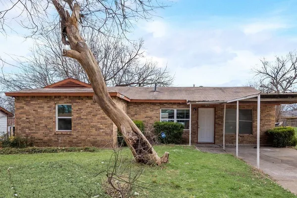 a view of a house with a yard porch and a tree