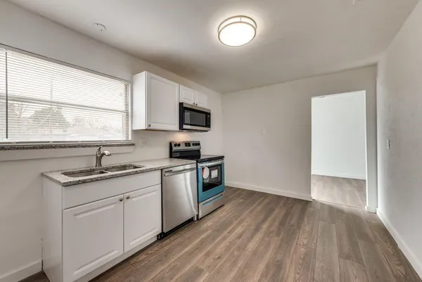 a kitchen with a sink a window and appliances