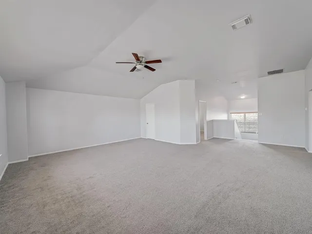 a view of a room with a ceiling fan