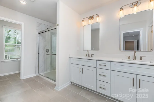 a bathroom with a double vanity sink mirror and