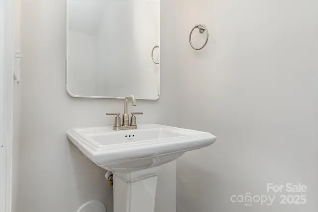 a bathroom with a sink and mirror