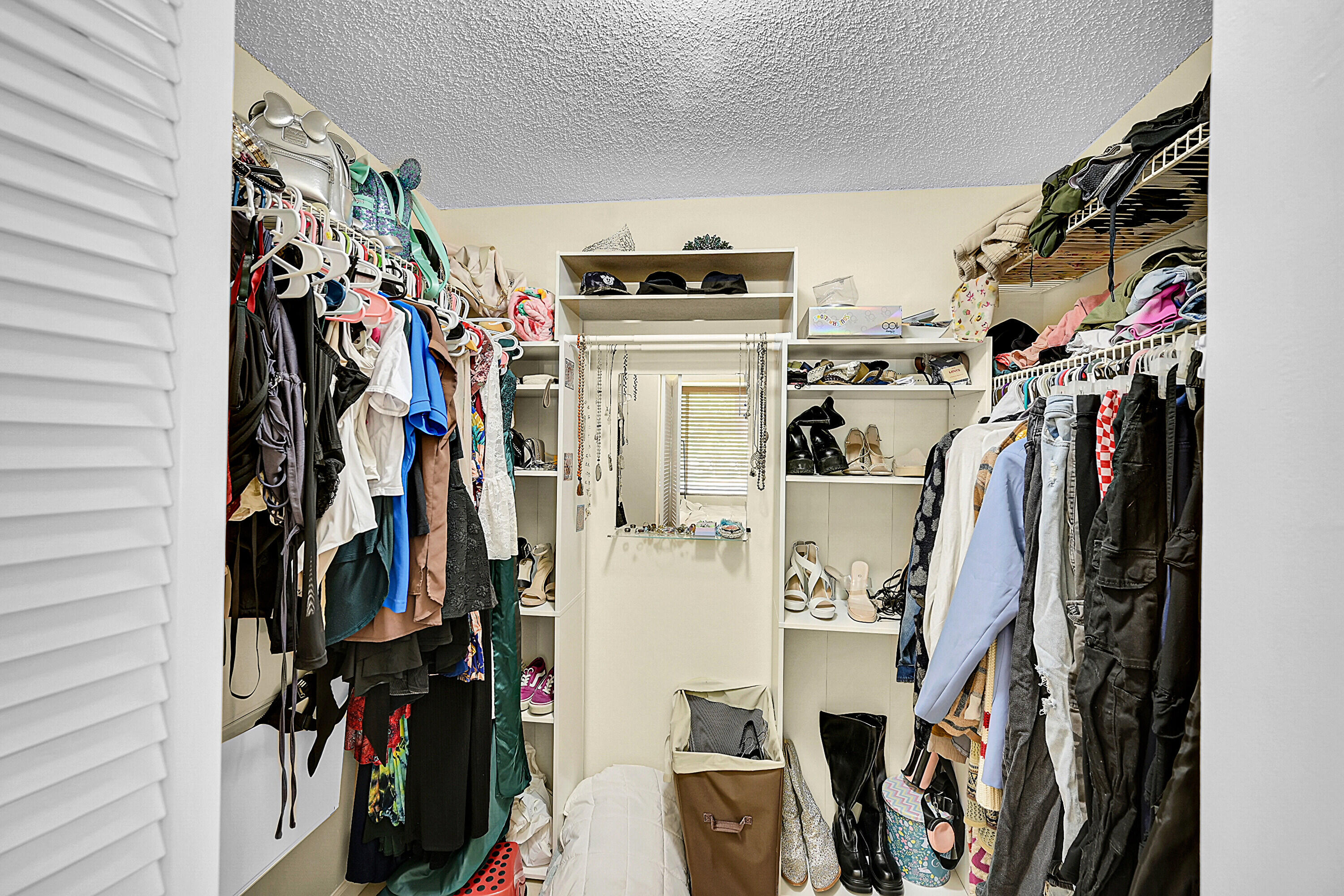 931 Lyons Road, Unit 4201 Coconut Creek, FL 33063 - Photo 12 of 47 a view of walk in closet with clothes