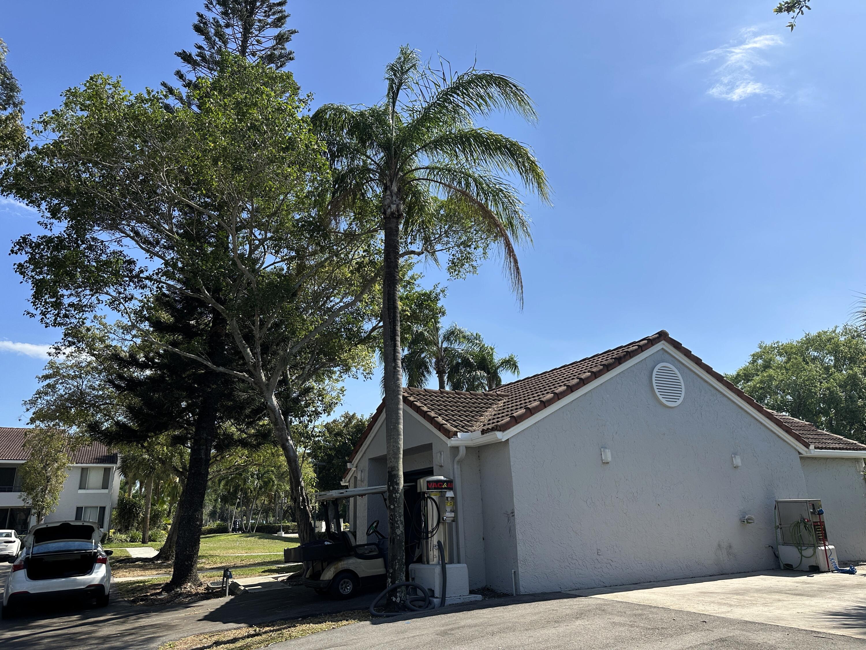 931 Lyons Road, Unit 4201 Coconut Creek, FL 33063 - Photo 33 of 47 a front view of a house with a tree