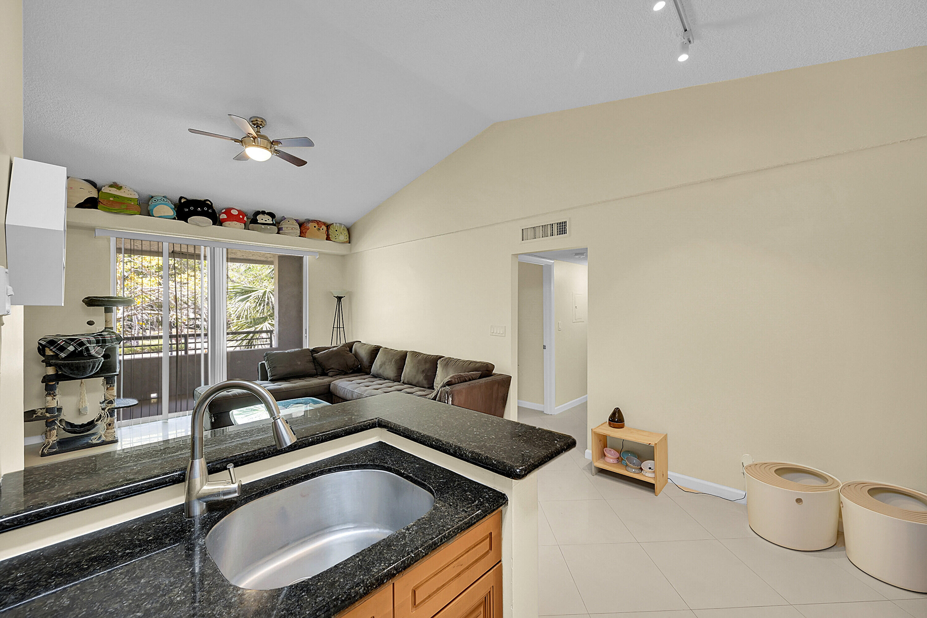 931 Lyons Road, Unit 4201 Coconut Creek, FL 33063 - Photo 6 of 47 a living room with furniture a flat screen tv and window
