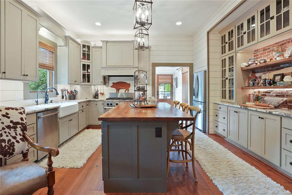745 Washington Street Clarkesville, GA 30523 - Photo 15 of 54 a kitchen with a sink a center island cabinets and appliances