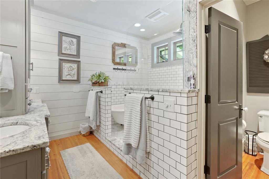 745 Washington Street Clarkesville, GA 30523 - Photo 30 of 54 a bathroom with a granite countertop sink a toilet and shower