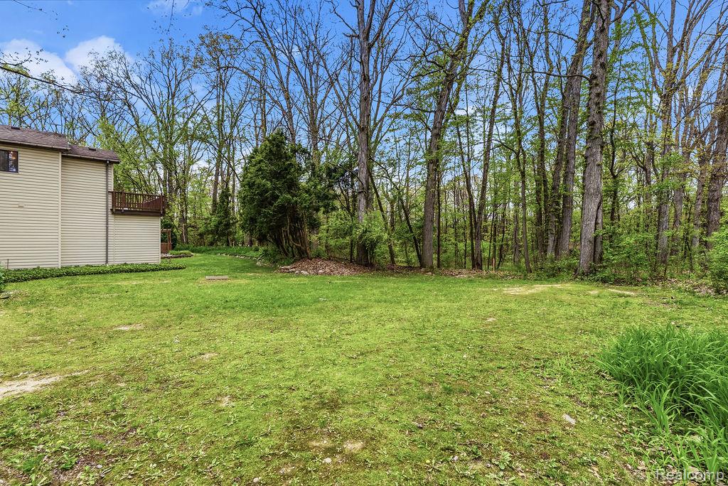 11111 Hibner Road Hartland, MI 48353 - Photo 48 of 59 View of green lawn featuring a wooden deck