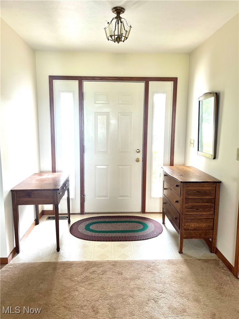3801 Hull Road Huron, OH 44839 - Photo 5 of 24 Carpeted foyer with baseboards and tile patterned floors
