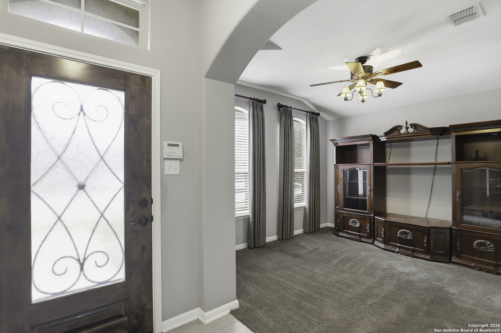 829 Laserra Cibolo, TX 78108 - Photo 2 of 15 a living room with furniture a flat screen tv and a wall painting