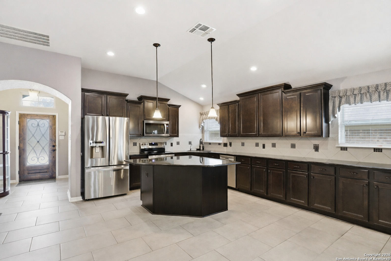 829 Laserra Cibolo, TX 78108 - Photo 3 of 15 a kitchen with stainless steel appliances granite countertop a refrigerator a sink a stove and a refrigerator
