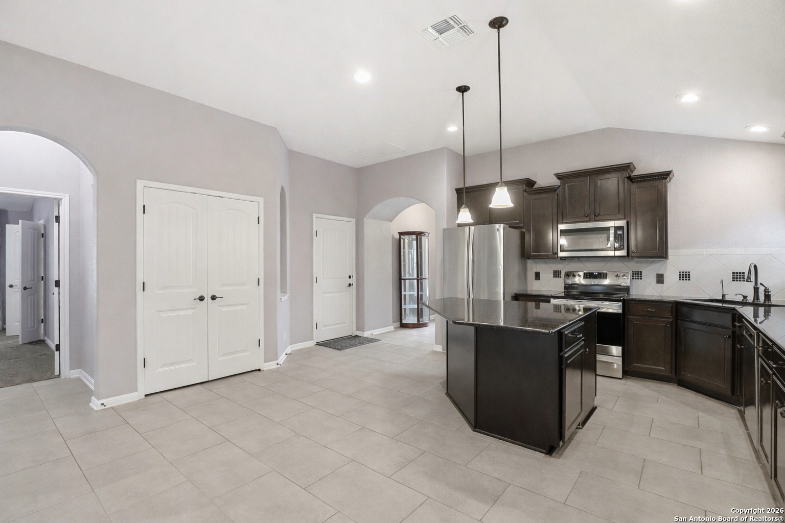 829 Laserra Cibolo, TX 78108 - Photo 5 of 15 a kitchen with stainless steel appliances kitchen island granite countertop a refrigerator a stove a sink and a oven