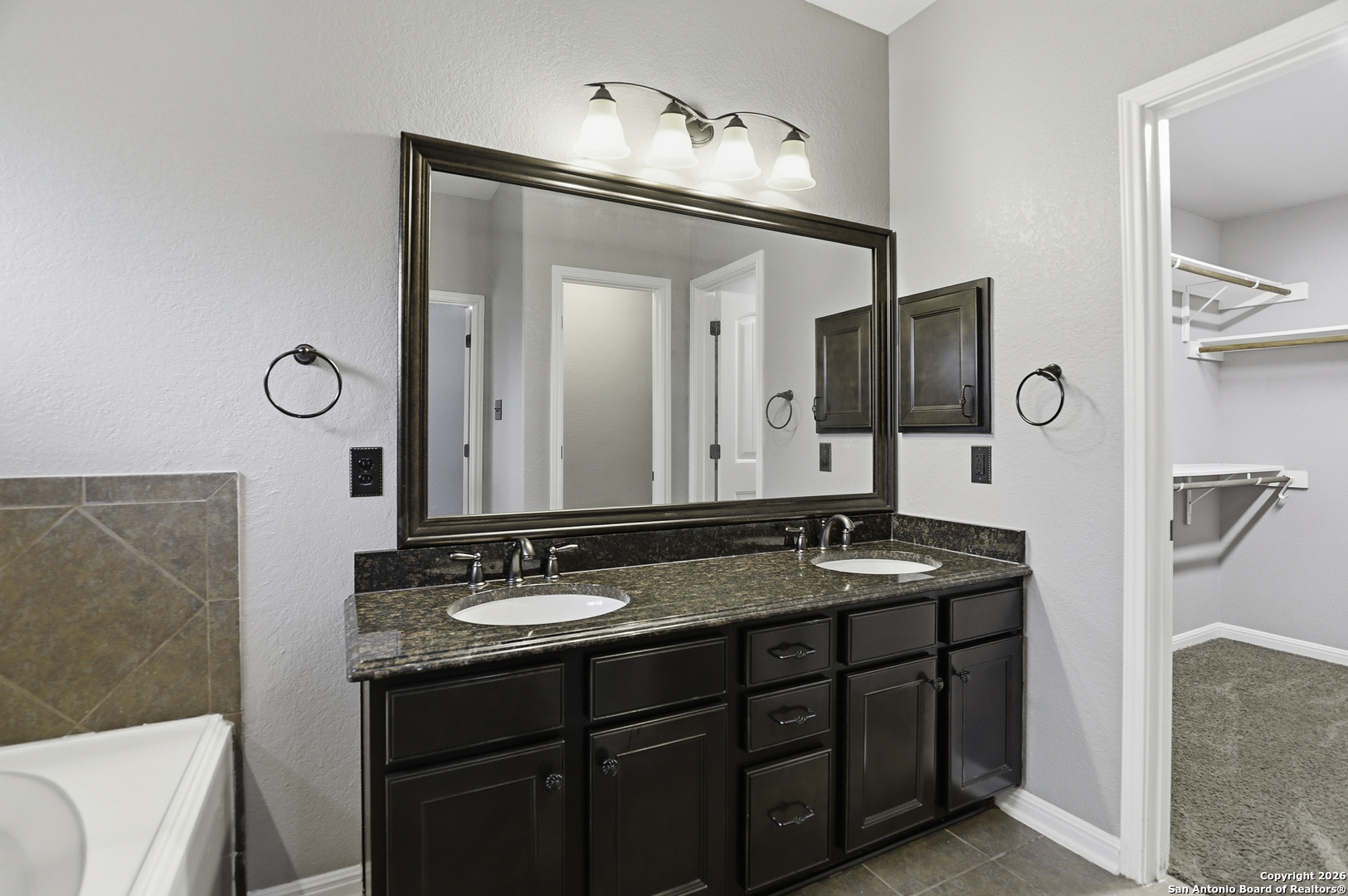 829 Laserra Cibolo, TX 78108 - Photo 9 of 15 a bathroom with a granite countertop sink and a mirror