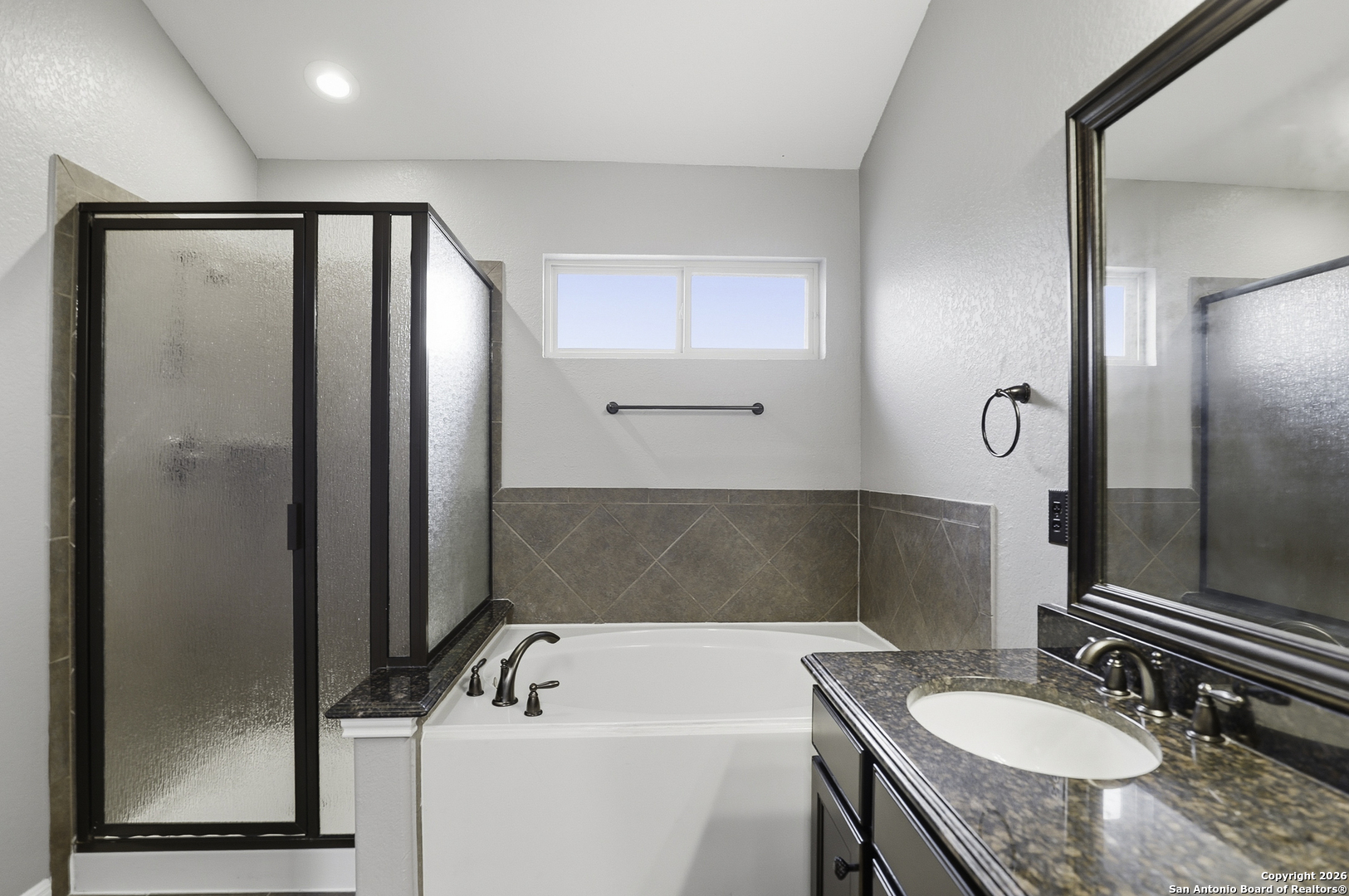 829 Laserra Cibolo, TX 78108 - Photo 10 of 15 a bathroom with a tub a sink and a mirror