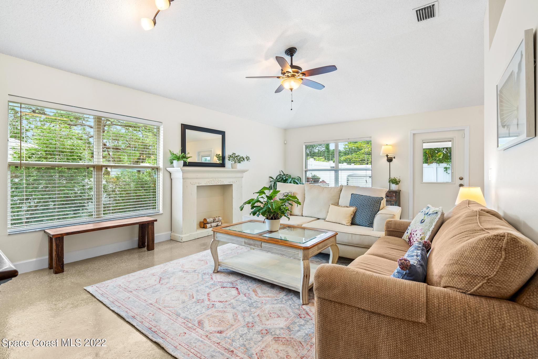 210 Hart Street Southwest Palm Bay, FL 32908 - Photo 3 of 26 a living room with furniture wooden floor and a large window