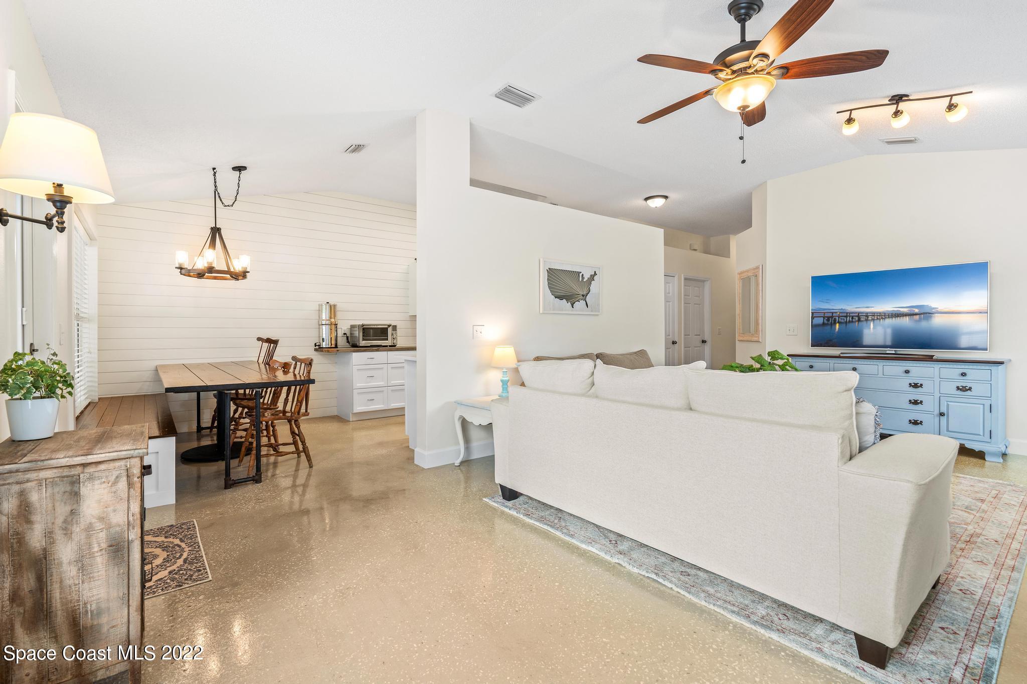 210 Hart Street Southwest Palm Bay, FL 32908 - Photo 4 of 26 a living room with furniture and a flat screen tv