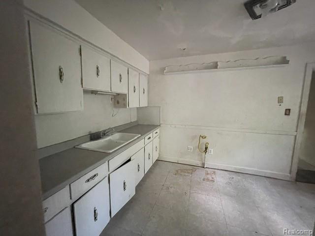 8930 Wayne Road Romulus, MI 48174 - Photo 5 of 18 Kitchen featuring upper and lower cabinetry, a double basin sink, and counter space