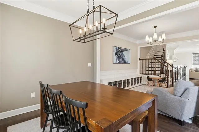 a view of a dining room with furniture and chandelier