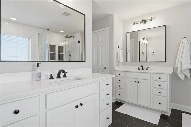 a bathroom with double sink and a mirror