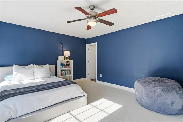 a bedroom with a large bed and a chandelier