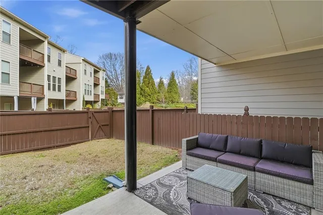 a view of a patio with a table and chairs