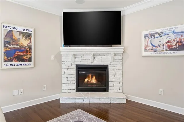 a living room with a fireplace and a flat screen tv